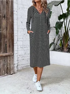 Casual long-sleeved hooded midi dress featuring classic black and white stripes and zip