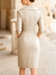 Back view of elegant beige slim-fit midi dress with waist detail and tailored collar.