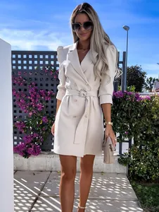 Elegant beige double-breasted blazer dress with a stylish belted waist and puff sleeves