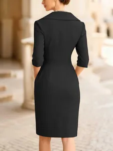 Elegant black slim-fit dress featuring a sophisticated back view and wide collar
