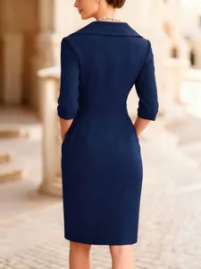 Detailed back view of an elegant navy blue slim-fit midi dress featuring a waist-cinching cut