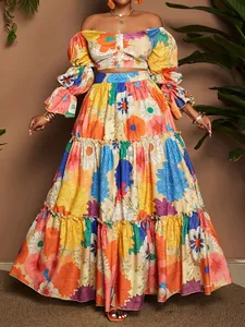 Detailed view of vibrant floral print two-piece set featuring off-shoulder top and tiered skirt