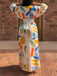 Back view of colorful brushstroke print two-piece long sleeve top and maxi skirt set