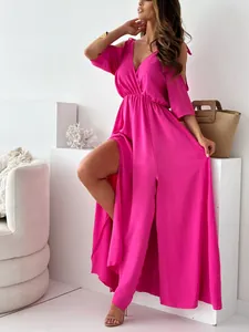 Detail view of a magenta V-neck cold-shoulder maxi dress with a sexy high leg slit.