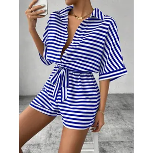 Chic blue and white striped summer romper with a button-up collar and waist tie.