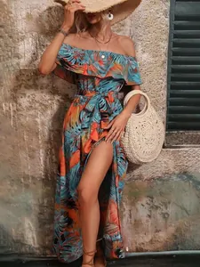 Detailed shot of tropical print off-shoulder maxi dress with ruffled neckline and slit