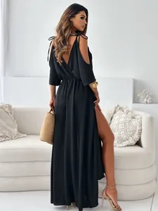 Elegant black V-neck maxi dress featuring high side slit and cold shoulder details.