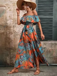 Full-body view of a tropical print off-shoulder maxi dress with ruffles and a waist tie.