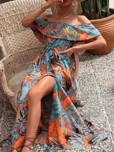 Detail of ruffled off-the-shoulder tropical print maxi dress with belted waist.
