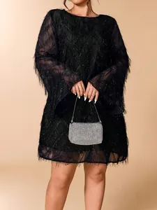 Detail view of plus size black feathered dress with shimmering silver rhinestone handbag