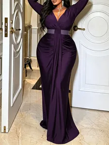 Detail view of an elegant purple V-neck long-sleeved dress with a belted waist design