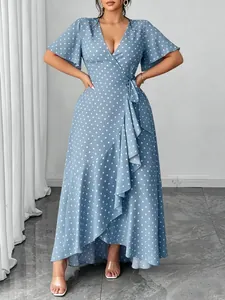 Detail view of a light blue V-neck polka dot maxi dress with ruffle trim and tie-waist