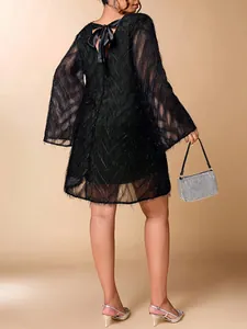 Back view of elegant plus size black dress featuring ruffle sleeves and bow tie detail