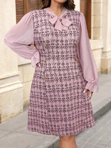 Close-up detail of pink tweed dress featuring mesh lantern sleeves and a bow tie neck