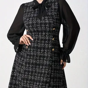 Close-up of elegant plus size tweed dress with black chiffon sleeves and bow tie
