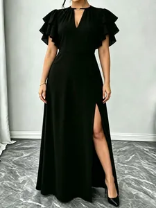 Close-up detail of an elegant black maxi dress featuring ruffle sleeves and a high slit