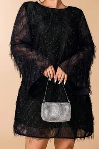 Macro detail view of elegant black sparkle fringe mini dress with long bell sleeves