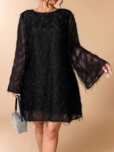 Elegant plus size black fringe short dress with ruffle sleeves shown on a model in studio