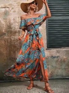 Detail showing tropical palm leaf print on off-the-shoulder ruffled summer maxi dress