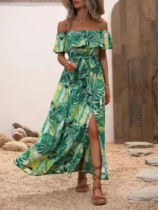 Detail view of off-the-shoulder ruffled maxi dress with tropical green leaf print