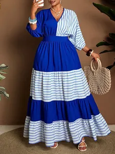 Close-up detail of tiered blue and white striped maxi dress with cinched waistline