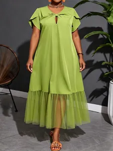 Detail view of a lime green plus size midi dress with mesh hem and knot neckline