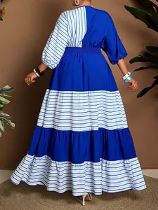 Back view of a stylish blue and white striped tiered maxi dress for plus size women