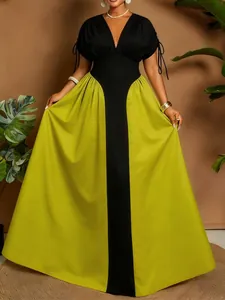 Detailed view of plus size color block maxi dress with V-neck and lime green pleated skirt.