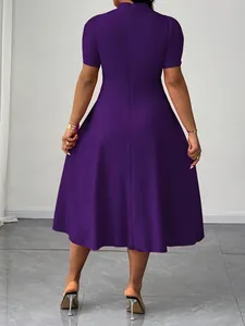 Vista posteriore di un elegante abito viola a maniche corte lungo fino al ginocchio.