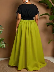 Back view detailing the smocked waist and long skirt of a color-block maxi dress.