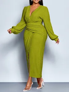 Elegant lime green pleated midi dress featuring a deep V-neck and long puff sleeves.