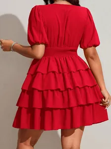 Back view of a vibrant red tiered mini dress with puff sleeves and smocked waist