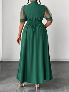 Back view detail of elegant green maxi dress with mesh patchwork sleeves and elastic waist