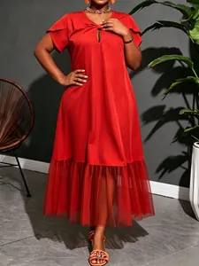 Detailed view of red plus size midi dress with mesh patchwork hem and V-neckline