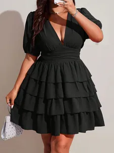 Close-up of black tiered ruffle dress with sexy V-neckline and puff sleeves details