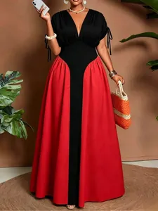 Detailed shot of a V-neck color-block maxi dress featuring side tie sleeves and a cinched waist
