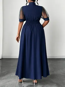 Back view of navy blue plus size midi dress with mesh sleeves and cinched waist