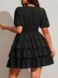 Back view detail of black tiered plus size mini dress with short puff sleeves.