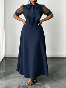Elegant navy blue midi dress featuring sheer mesh sleeves and a stylish bow neck tie