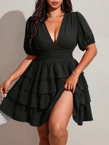 Elegant plus size black mini dress featuring a deep V-neck and tiered cake skirt detail