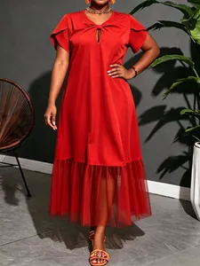 Detail of plus size red summer midi dress with mesh patchwork and knot detail