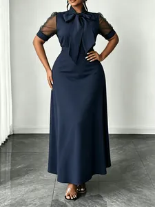 Elegant navy blue maxi dress with mesh puff sleeves and large bow collar detail