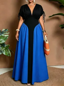 Detail view of a V-neck color-blocked maxi dress in black and blue with drawstring sleeves