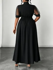 Elegant back view of black plus size maxi dress with mesh sleeves and an elastic waist detail