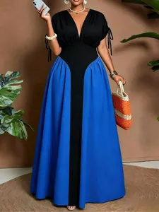 Elegant detail of a black and blue color-block maxi dress with V-neck and slim waist
