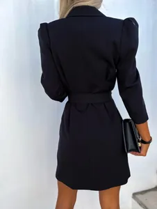 Elegant back view of a black puff-sleeved blazer dress with a matching waist belt detail