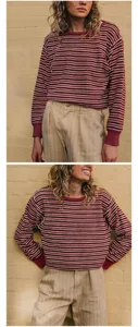 Detail of a women's vintage red striped crewneck knit sweater with soft ribbed cuffs