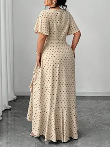 Elegant back view of a plus size beige polka dot midi dress with a ruffled hem