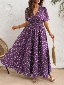 Detailansicht des eleganten lila Kleides mit V-Ausschnitt, Blumenmuster und Taille.