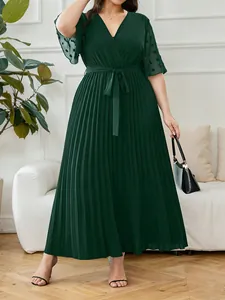 Elegant plus size dark green pleated maxi dress with V-neck and waist tie design.